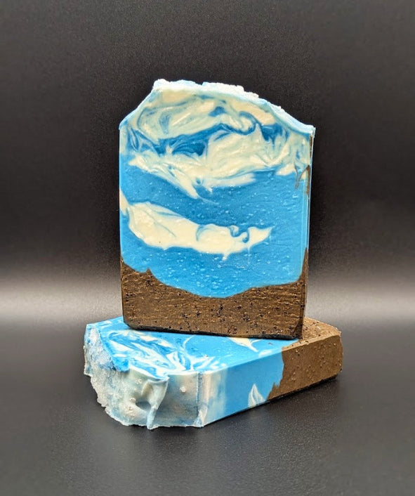 Marble-patterned soap bar with blue and white design on a dark background
